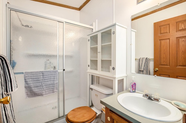 bathroom featuring crown molding, vanity, toilet, and an enclosed shower