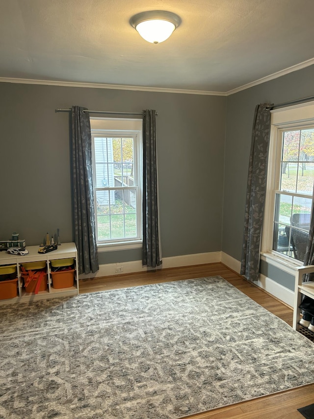 living area featuring crown molding and hardwood / wood-style floors