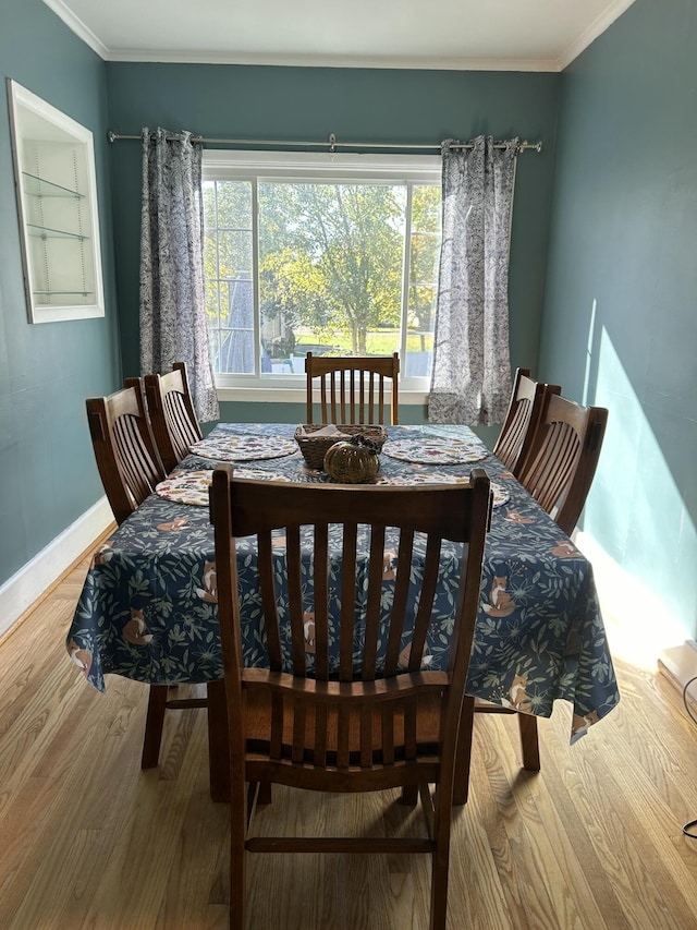 dining area featuring crown molding and wood-type flooring