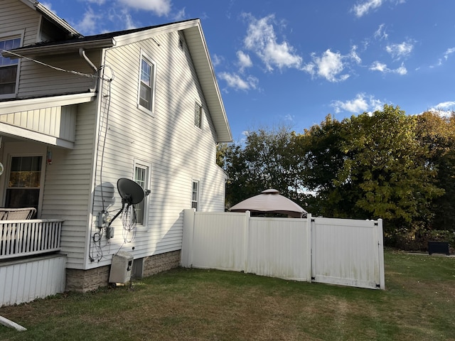 view of property exterior with a lawn