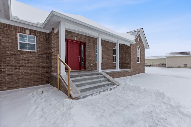 view of snow covered property entrance