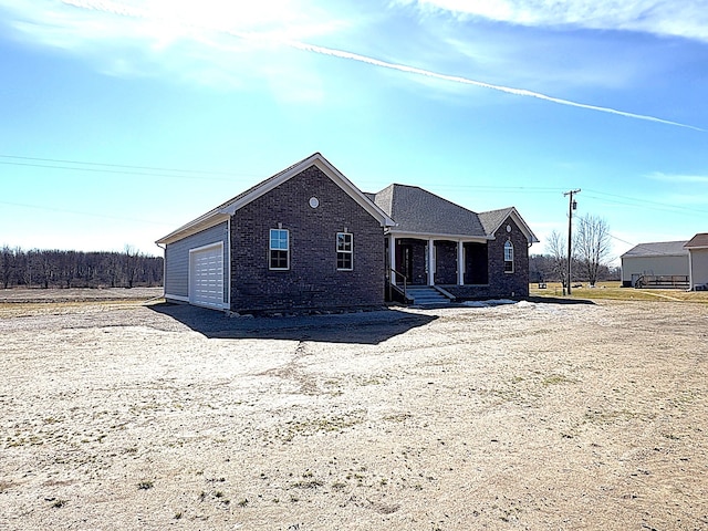 view of front of house featuring brick siding and an attached garage