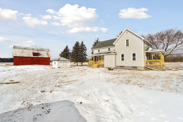 snow covered property featuring a porch