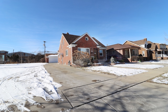 view of front of property with a garage and an outdoor structure