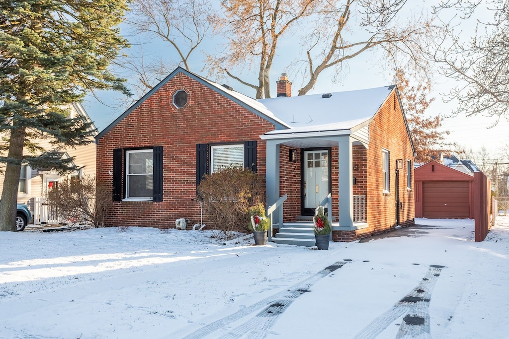 view of front of home featuring a garage and an outdoor structure