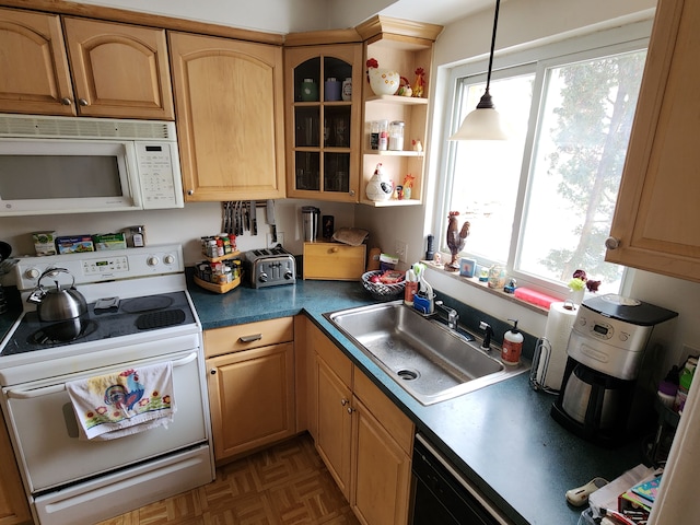 kitchen featuring pendant lighting, white appliances, sink, and dark parquet floors