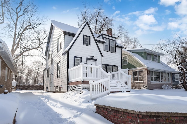 view of snow covered back of property