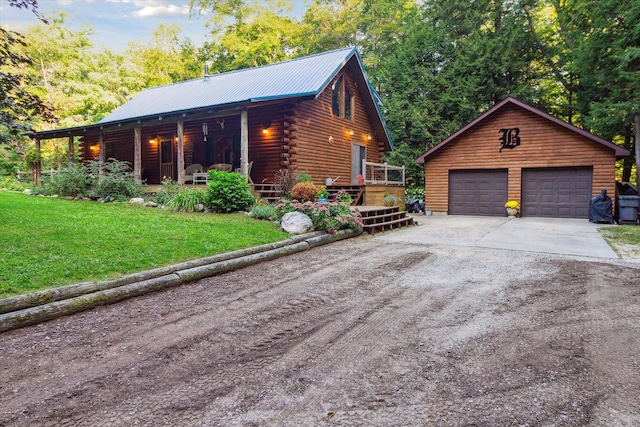 view of home's exterior with a porch, a garage, a lawn, an outdoor structure, and a deck