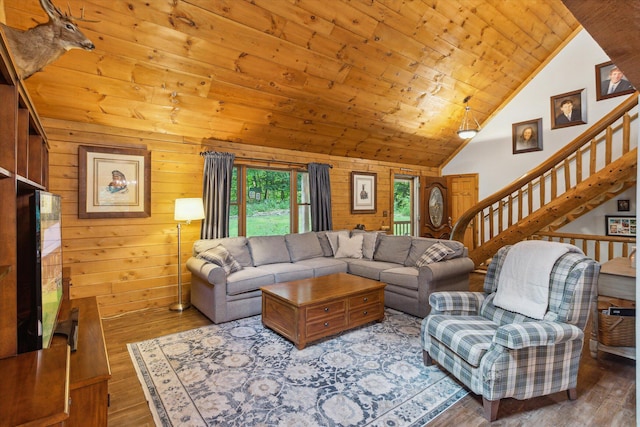 living room with hardwood / wood-style flooring, wood walls, high vaulted ceiling, and wooden ceiling