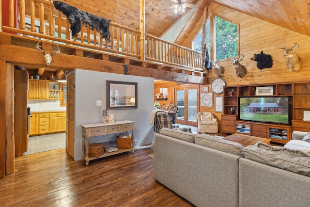 living room featuring french doors, wood ceiling, wood-type flooring, high vaulted ceiling, and wooden walls