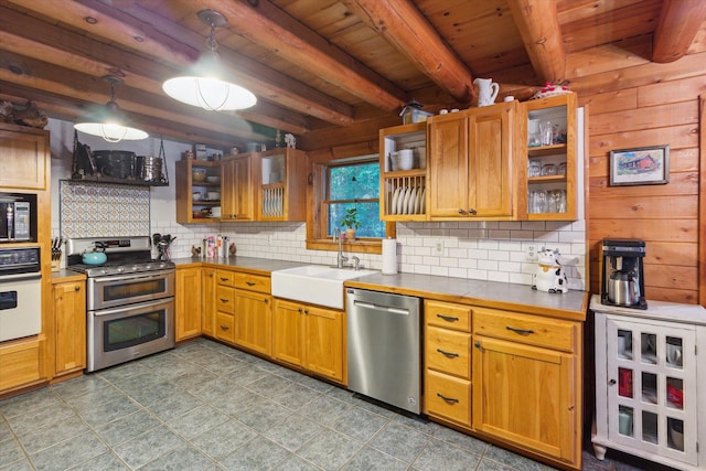 kitchen with decorative light fixtures, beamed ceiling, sink, wood ceiling, and stainless steel appliances