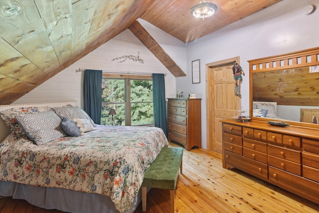 bedroom with wood ceiling, vaulted ceiling, and light wood-type flooring