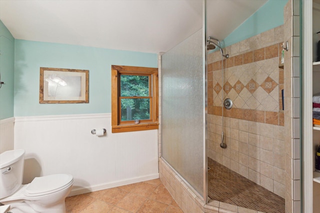 bathroom featuring tile patterned flooring, an enclosed shower, and toilet