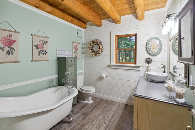 bathroom featuring a washtub, wood ceiling, wood-type flooring, beamed ceiling, and toilet