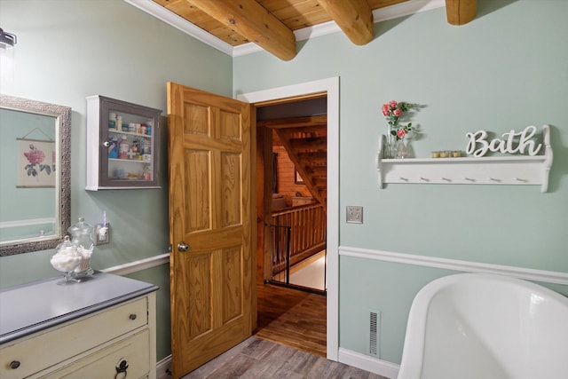 bathroom featuring a bath, hardwood / wood-style floors, wood ceiling, and beam ceiling