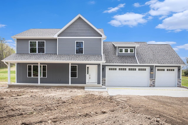 view of front of house with a porch and a garage