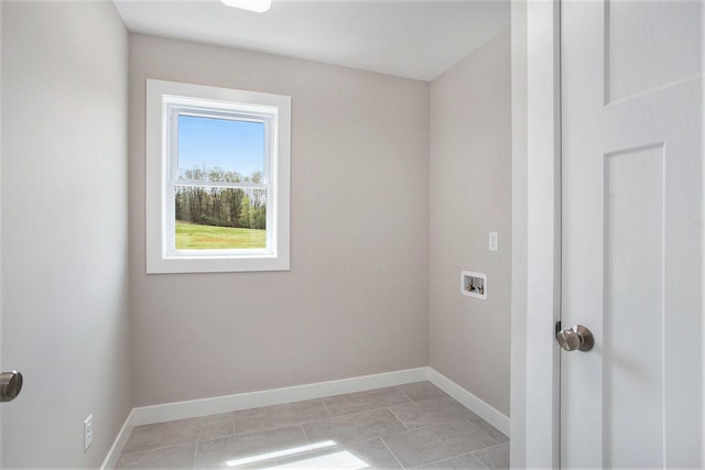 washroom with light tile patterned floors and hookup for a washing machine