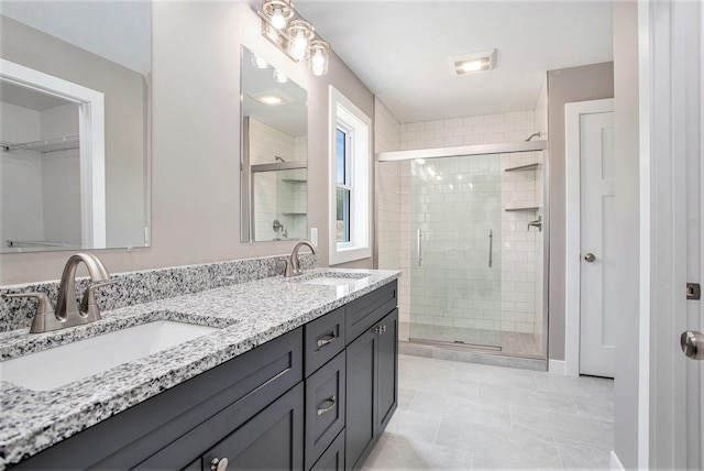 bathroom with vanity, tile patterned flooring, and a shower with shower door