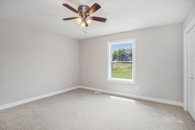 spare room with ceiling fan and carpet flooring