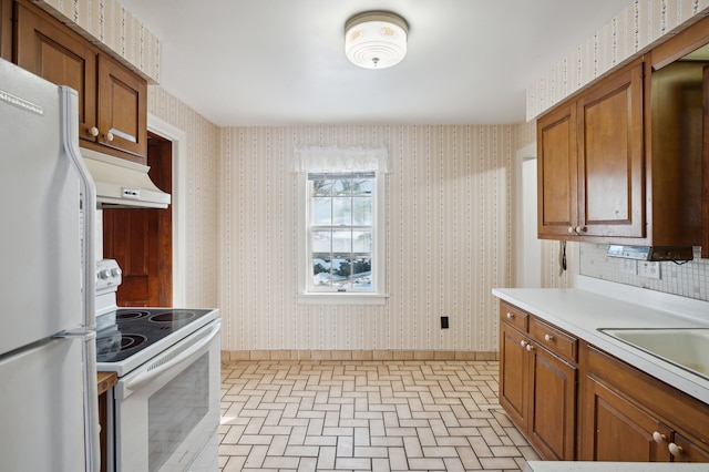 kitchen featuring white appliances and sink