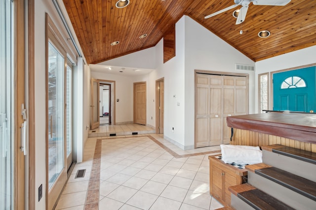 tiled foyer entrance featuring wood ceiling and vaulted ceiling