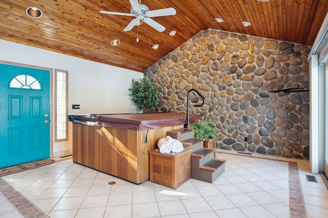 foyer entrance featuring lofted ceiling, wood ceiling, ceiling fan, a healthy amount of sunlight, and light tile patterned flooring