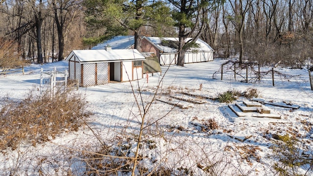 snowy yard featuring an outdoor structure