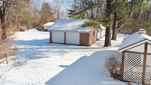 exterior space with an outbuilding and a garage