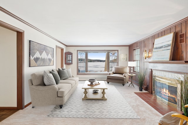 carpeted living room with a tile fireplace and ornamental molding