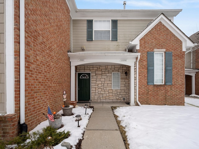 view of snow covered property entrance