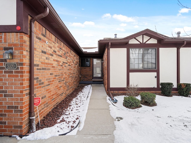 view of snow covered property entrance