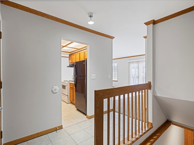 corridor featuring crown molding and light tile patterned floors