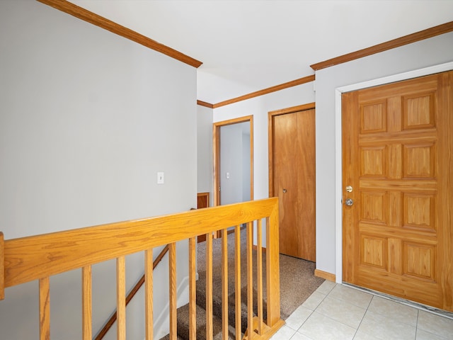 foyer entrance featuring ornamental molding and light tile patterned floors