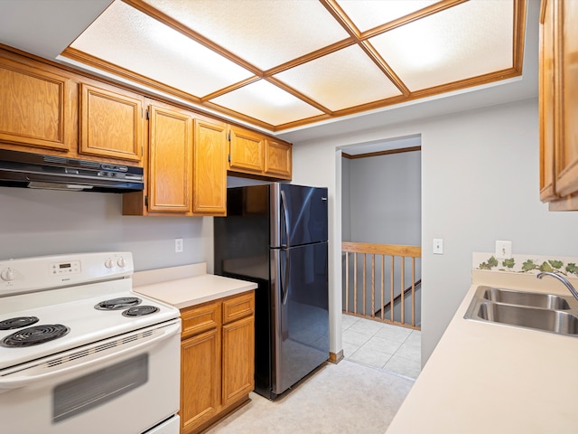 kitchen featuring refrigerator, sink, and white range with electric stovetop