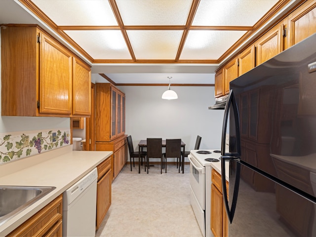 kitchen with sink, white appliances, and decorative light fixtures