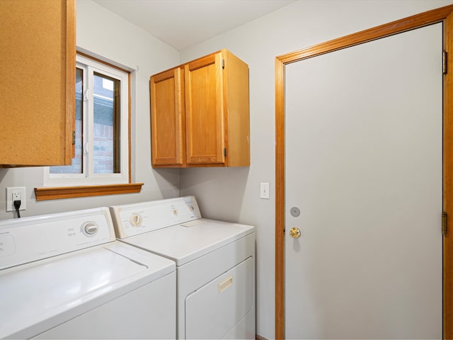 laundry room featuring cabinets and washing machine and dryer