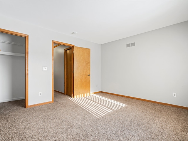 unfurnished bedroom featuring carpet flooring and a closet