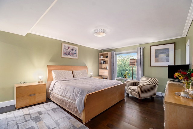 bedroom with ornamental molding and dark hardwood / wood-style floors