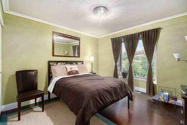 bedroom with wood-type flooring and ornamental molding