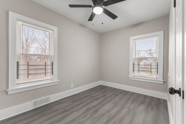 spare room featuring dark hardwood / wood-style floors and ceiling fan