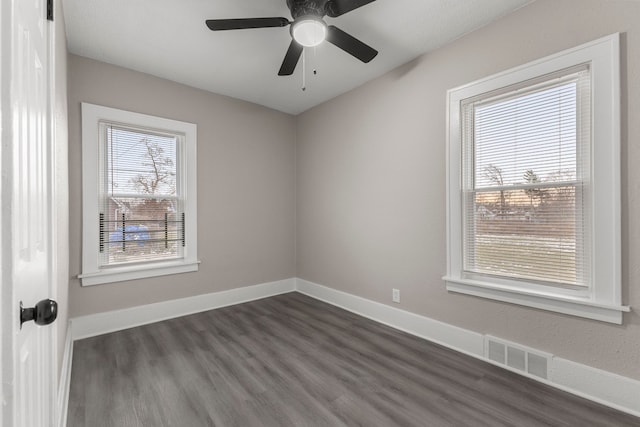 unfurnished room featuring dark wood-type flooring and ceiling fan