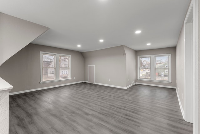 bonus room featuring dark hardwood / wood-style flooring, vaulted ceiling, and a wealth of natural light