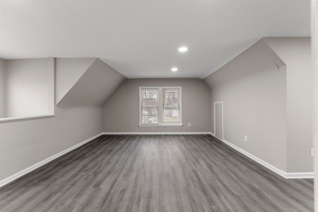 bonus room with lofted ceiling and dark hardwood / wood-style floors