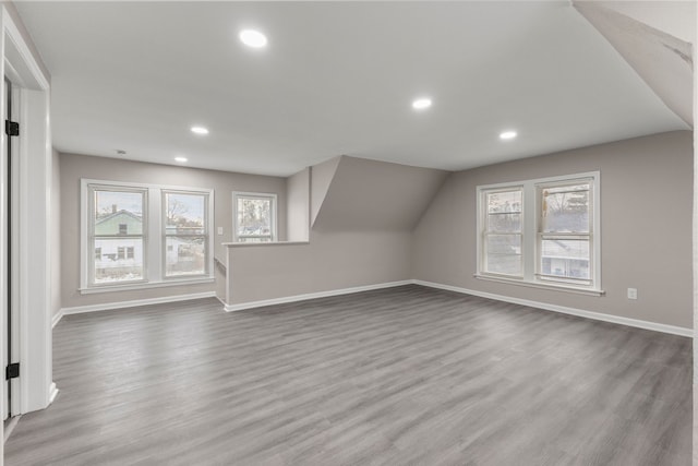 bonus room featuring wood-type flooring and vaulted ceiling