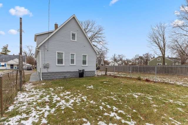 rear view of property featuring a yard