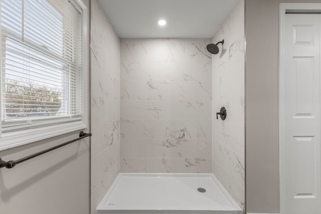 bathroom with a tile shower