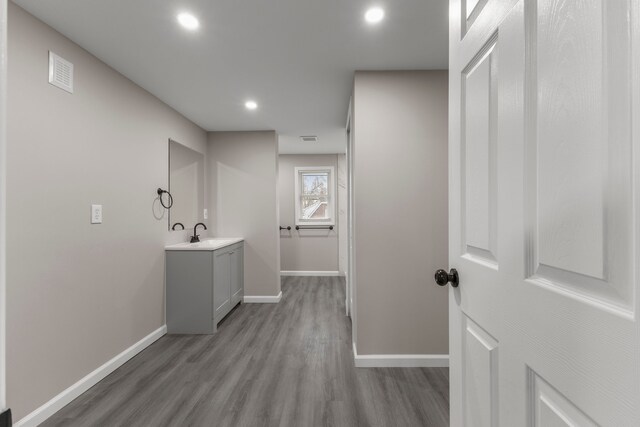 interior space with vanity and hardwood / wood-style floors