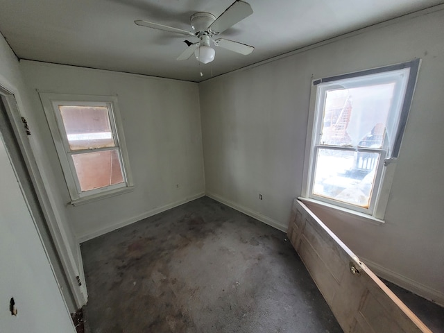 spare room featuring plenty of natural light and ceiling fan