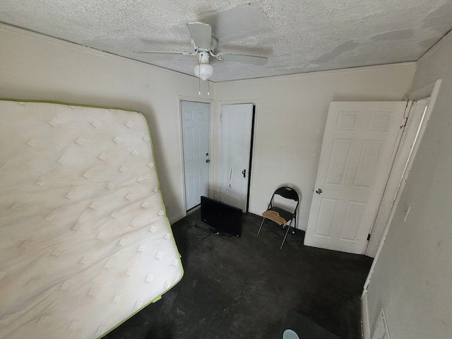 unfurnished bedroom with ceiling fan, dark carpet, and a textured ceiling