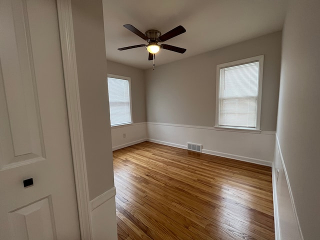 empty room featuring ceiling fan and light wood-type flooring